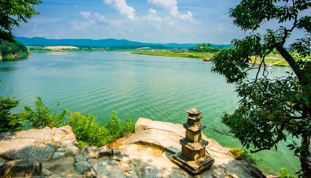 Blick auf das smaragdgrüne Wasser der Hangang, im Vordergrund am Ufer steht eine kleine Statue