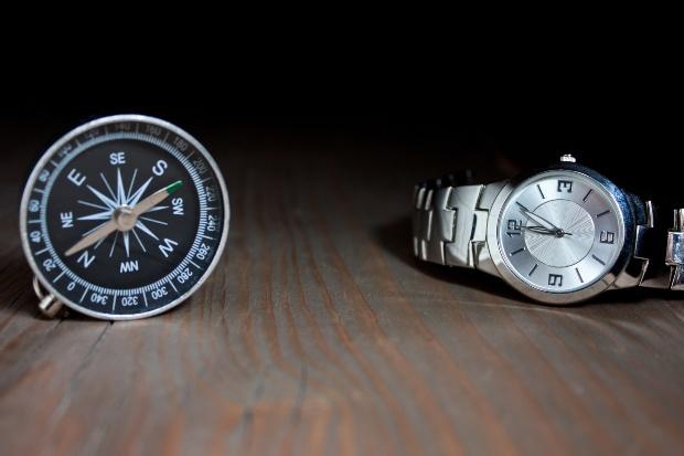 Armbanduhr liegt neben einem Kompass - möglicherweise muss man die Uhr entmagnetisieren