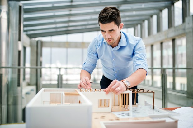 Junger Architekt im Büro - Architekten Uhren