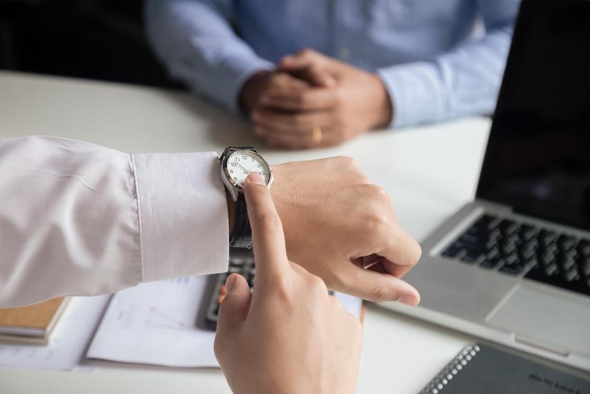 Someone points to his wristwatch - The automatic watch is slow