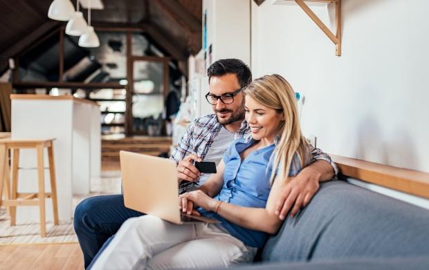 Young couple, online shopping by laptop